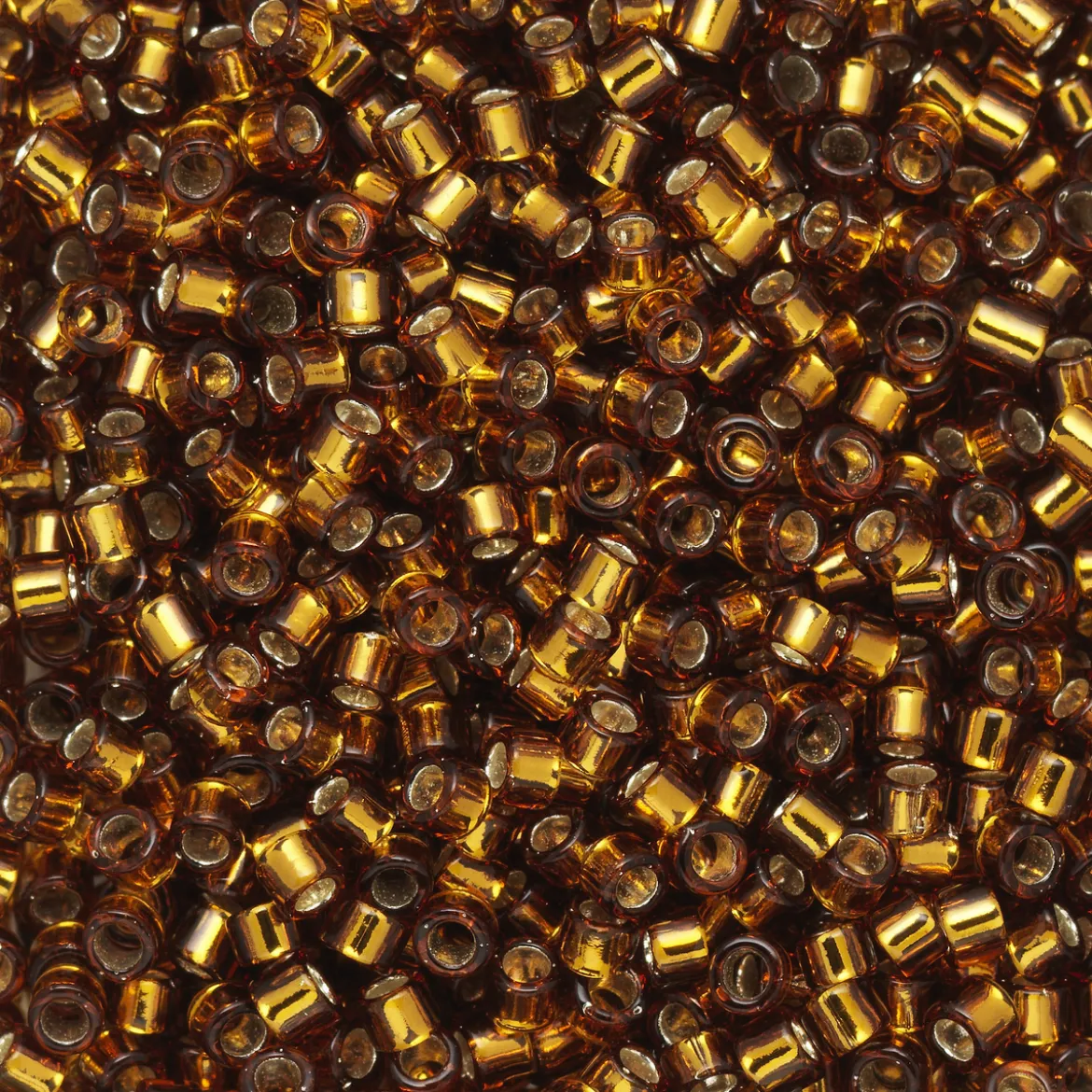 TOHO-perler 11/0 – brun silverline, 34 Silver-lined smoky topaz